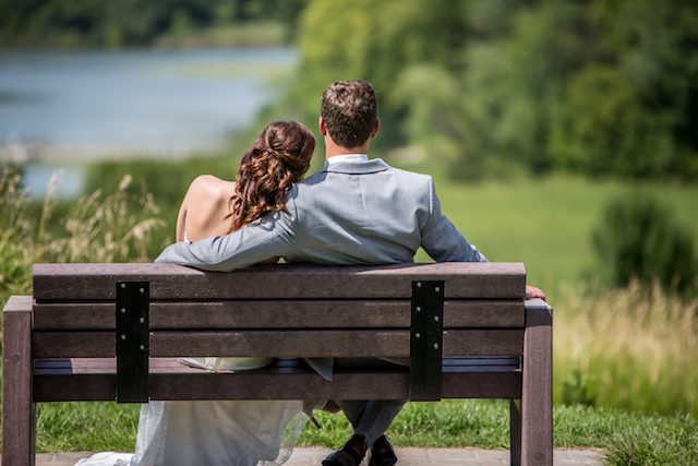 bride with hair half up and half down | groom in a gray suit